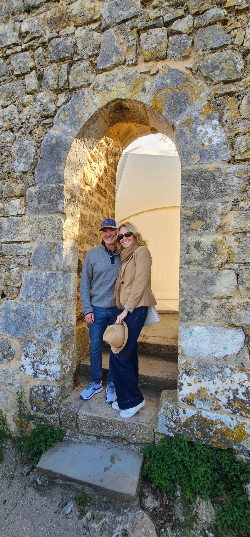 Guests inside a Manueline stone archway at Óbidos