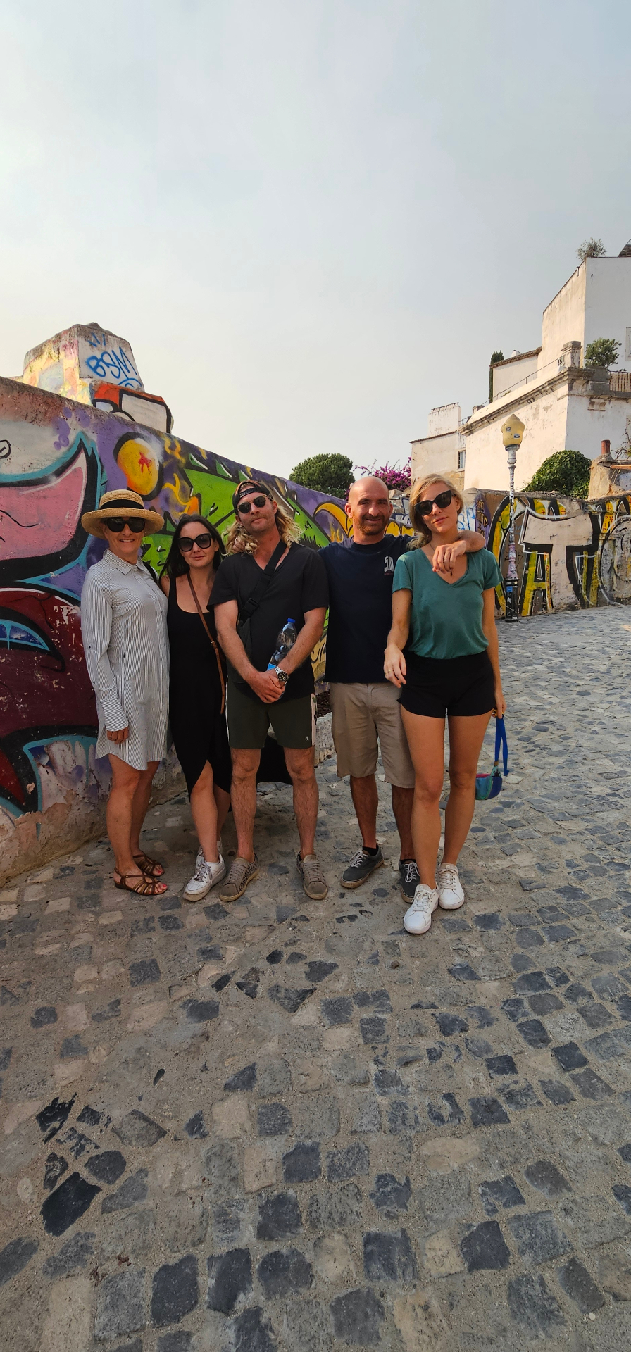 Group beside a street-art wall in Lisbon