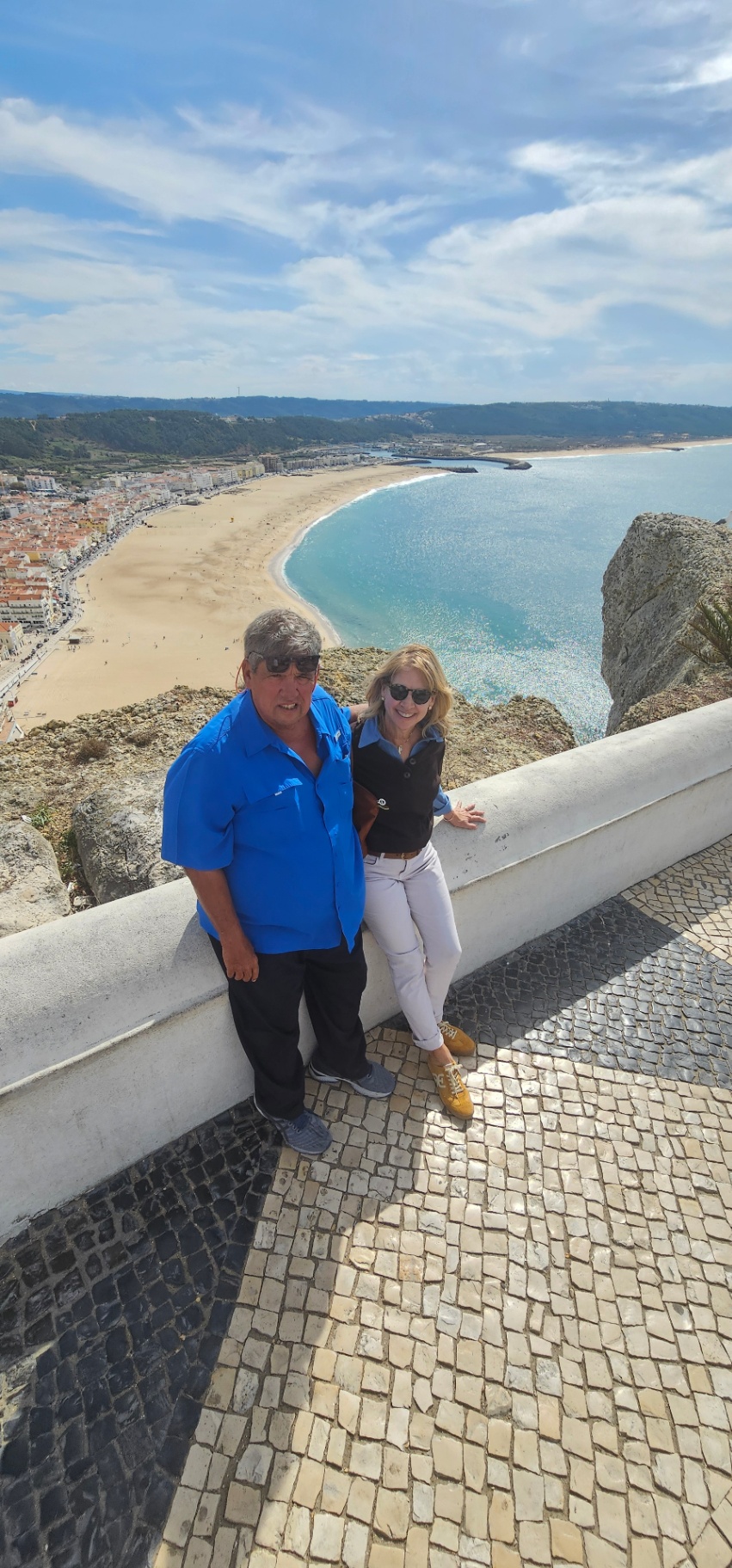 Guests at the Sítio da Nazaré viewpoint above the crescent bay