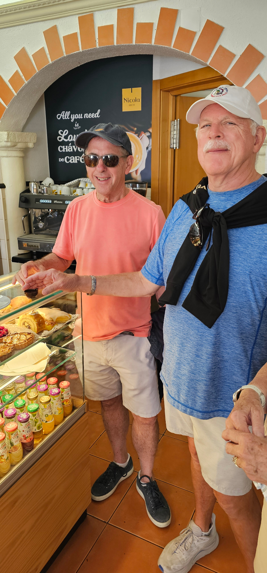Guests at a traditional Portuguese pastelaria choosing pastries