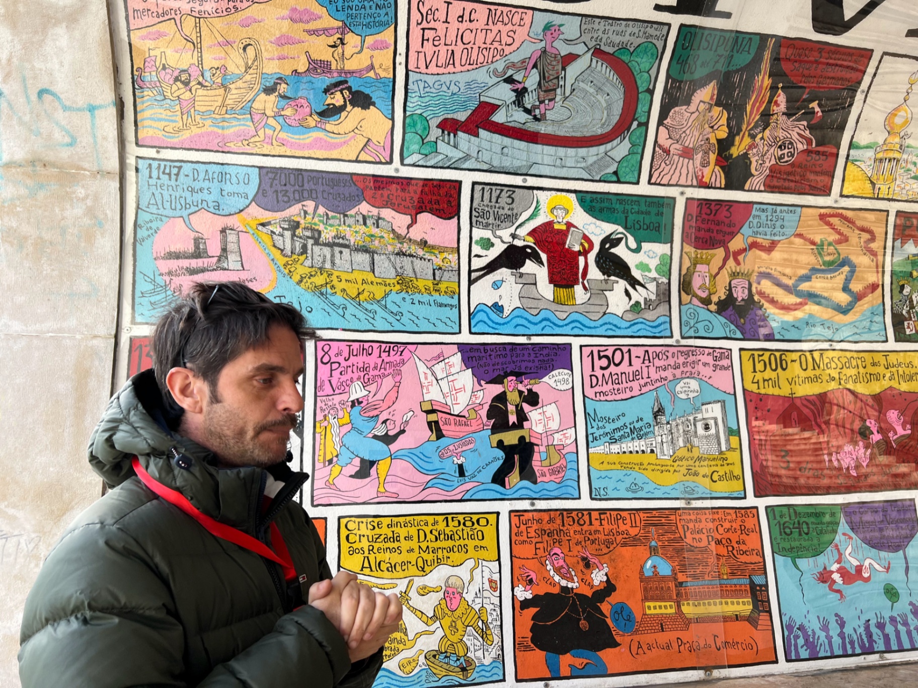 Eduardo explaining Lisbon's history at the painted timeline wall