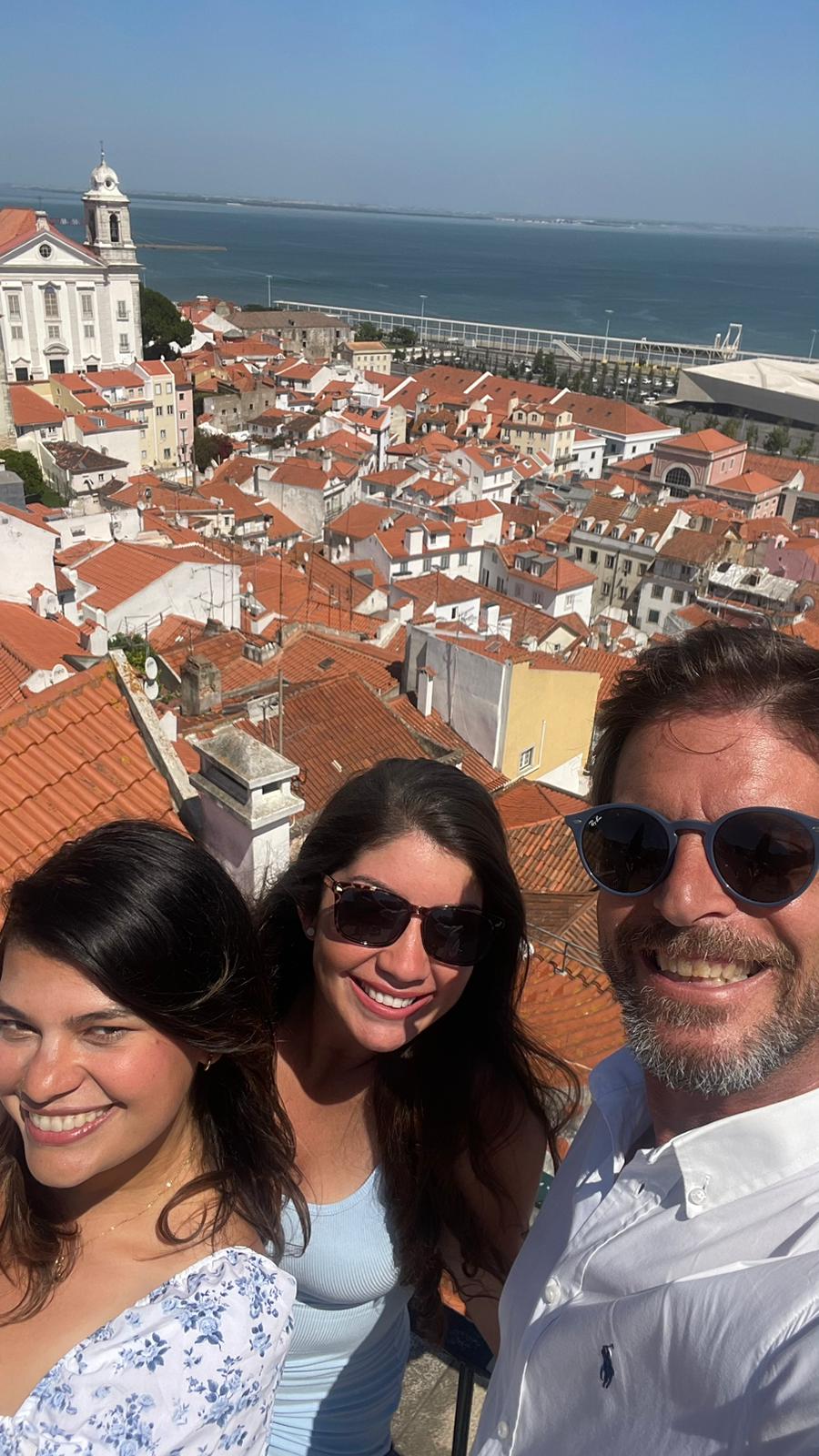 Guests with Eduardo at a Lisbon miradouro over the river