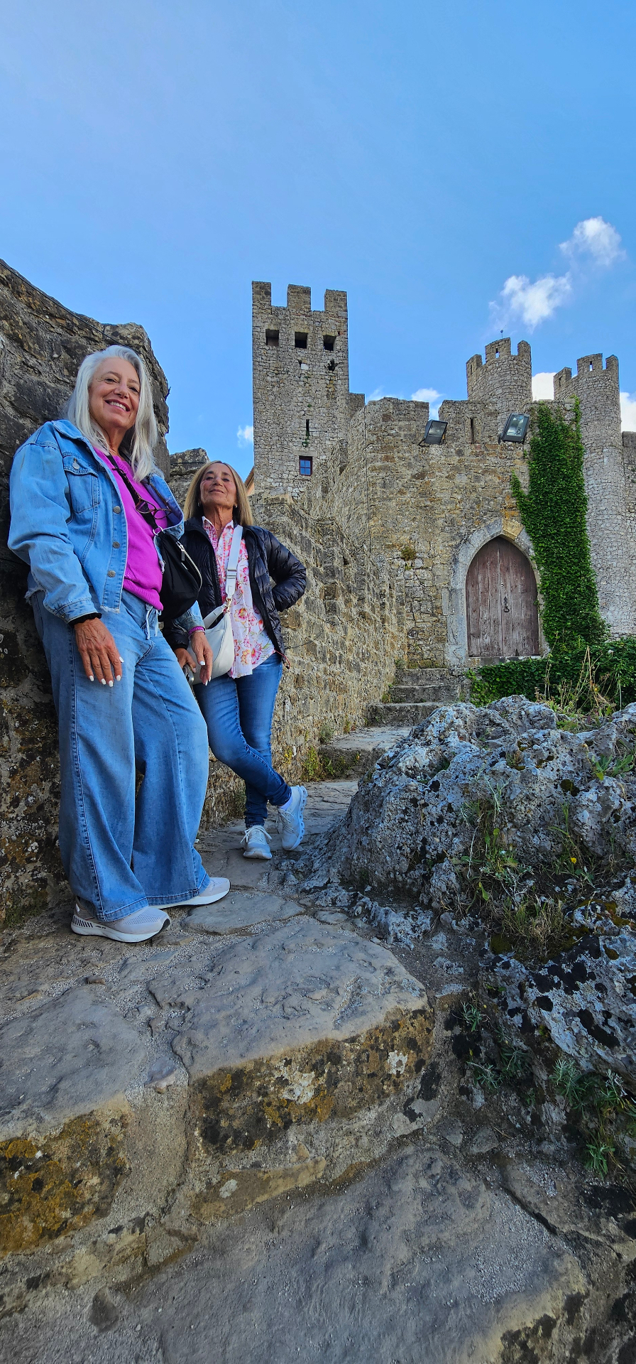 Guests below the towers and battlements of Óbidos Castle
