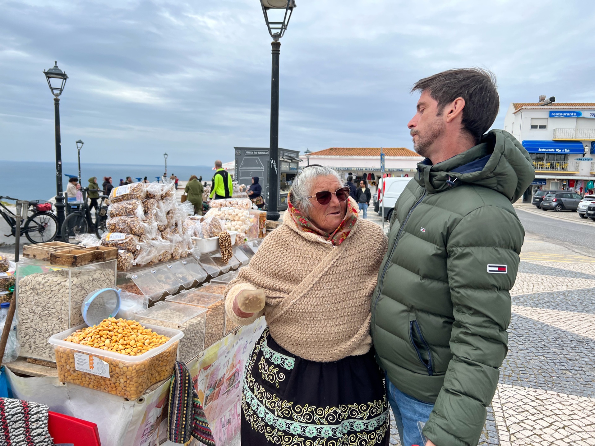 Eduardo with a traditional Nazaré vendor in her seven-skirt costume at the seafront market